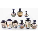 A group of Japanese blue ground pottery vases, decorated with reserves of figures, flowers and grass