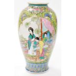 An early 20thC Cantonese famille rose porcelain vase, of baluster form, decorated with reserves of f