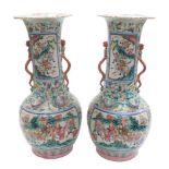 A pair of Chinese associated Canton vases, of bottle form with elongated neck and flared rim, decora