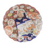 A Meiji period Japanese Imari charger, with scalloped border and hand painted decorative scroll pane