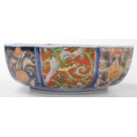 A 20thC Japanese Imari bowl, of octagonal form, decorated with panels of exotic birds, dragons, and