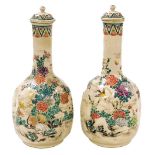 A pair of Meiji period Japanese Satsuma bottle vases and covers, of lobed form, enamel decorated wit