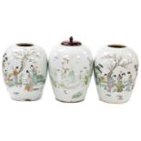 Three early 20thC Chinese jars, one with turned wood cover, decorated in famille rose palette with f