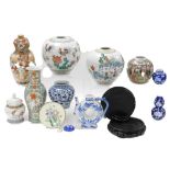 A group of Chinese and Japanese pottery and porcelain, including vases, and hardwood stands. (1 box)