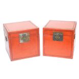 A pair of Chinese red lacquer chests, of square section, with twin carrying handles, each 40cm high,