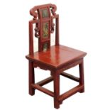 A 19thC Chinese red lacquer child's chair, with gilt decoration.