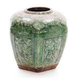 A Chinese green glazed hexagonal pottery jar, with rectangular low relief floral panels, 19thC, 16cm