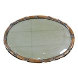 A 19thC Chinese bevelled oval hardwood wall mirror, with hardwood frame in the form of bamboo, 62cm