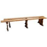 A pair of English elm benches, with slab supports, 297cm long.