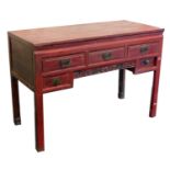 A Chinese red lacquer side table, with drawers, 90cm high, 130cm wide, 56cm deep.