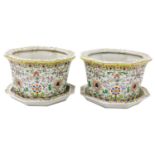 A pair of late 20thC Chinese famille rose porcelain jardinieres on stands, of octagonal form, decora