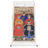 A Chinese ceremonial ancestor portrait scroll, depicting seven family members in front of an altar t