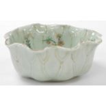 A 19thC celadon porcelain bowl, modelled as a lily pad, enamelled with flowers, 17cm wide