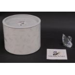 A Swarovski figurine swan, 5cm high, boxed with paperwork.