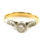 A solitaire diamond ring, 0.20ct approx diamond with tiny stone set shoulders on yellow metal shank,