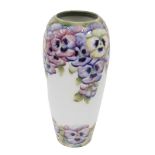 An early 20thC Macintyre Moorcroft pottery pansies pattern vase, on white ground, printed and script