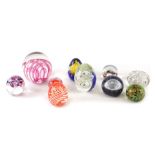 Various glass paperweights, red swirl design 8cm high, various others. (a quantity)