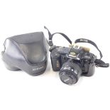 A Nikon F-401 camera, JCII, with lens, 10cm high. (cased)