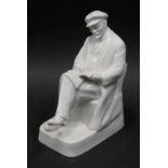 A Dulevo style undecorated porcelain figure of Lenin, seated reading, unmarked, 22cm high.