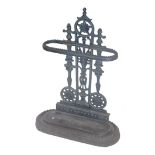 A Victorian style cast iron umbrella stand, with pierced back, beaded oblong compartment and removab