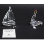 A Swarovski crystal sea lion and ball group, 8cm high, and another ship ornament. (2, boxed)