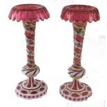 A pair of 19thC Bohemian ruby glass vases, with gilt highlighted floral tops, on turned stems, hand