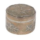 An early 20thC Wang Hing Chinese white metal powder box, repousse decorated with trees, on a hammere