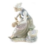 A 20thC Copenhagen style porcelain figure, of a lady and child beside basket, impressed marks beneat