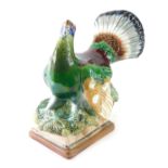 A Konakov figure of a capercaillie, on naturalistic base, polychrome decorated, marked beneath, 29cm
