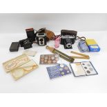 A Haminex slidelite, Agfa ISO 1 ette, Brownie Reflex, coins, cranberry glass, etc. (1 tray)