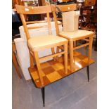A retro coffee table, with birds eye finish and teak top, on turned legs, and two kitchen chairs. Th