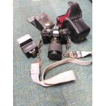 A Minolta camera, X-700, with F=28-100mm 1:3.5-5.5 lens, and a further Minolta flash.