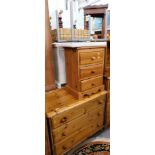 A pine pedestal cabinet, chest of three drawers, and a stool.