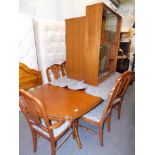 An extending dining table, five (4+1) dining chairs, bookcase and chest of five drawers.