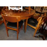 A teak dining room table, bentwood G-Plan style chairs, in black leather. The upholstery in this lot
