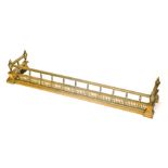 A late 19th/early 20thC brass fire curb or fender, in Neo Classical style with a turned and pierced