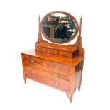 An Edwardian mahogany and satinwood cross banded dressing table, the raised back with three drawers,