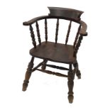 A 20thC smoker's bow style railway chair, with carved back, scroll arm supports on turned supports,