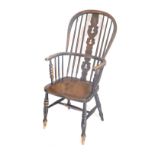 A 19thC ash and elm Windsor armchair, with a pierced splat, turned legs an H stretcher.