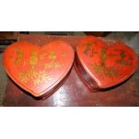 A pair of Chinese red and gilt lacquer heart shaped boxed and covers, each decorated with vases of f