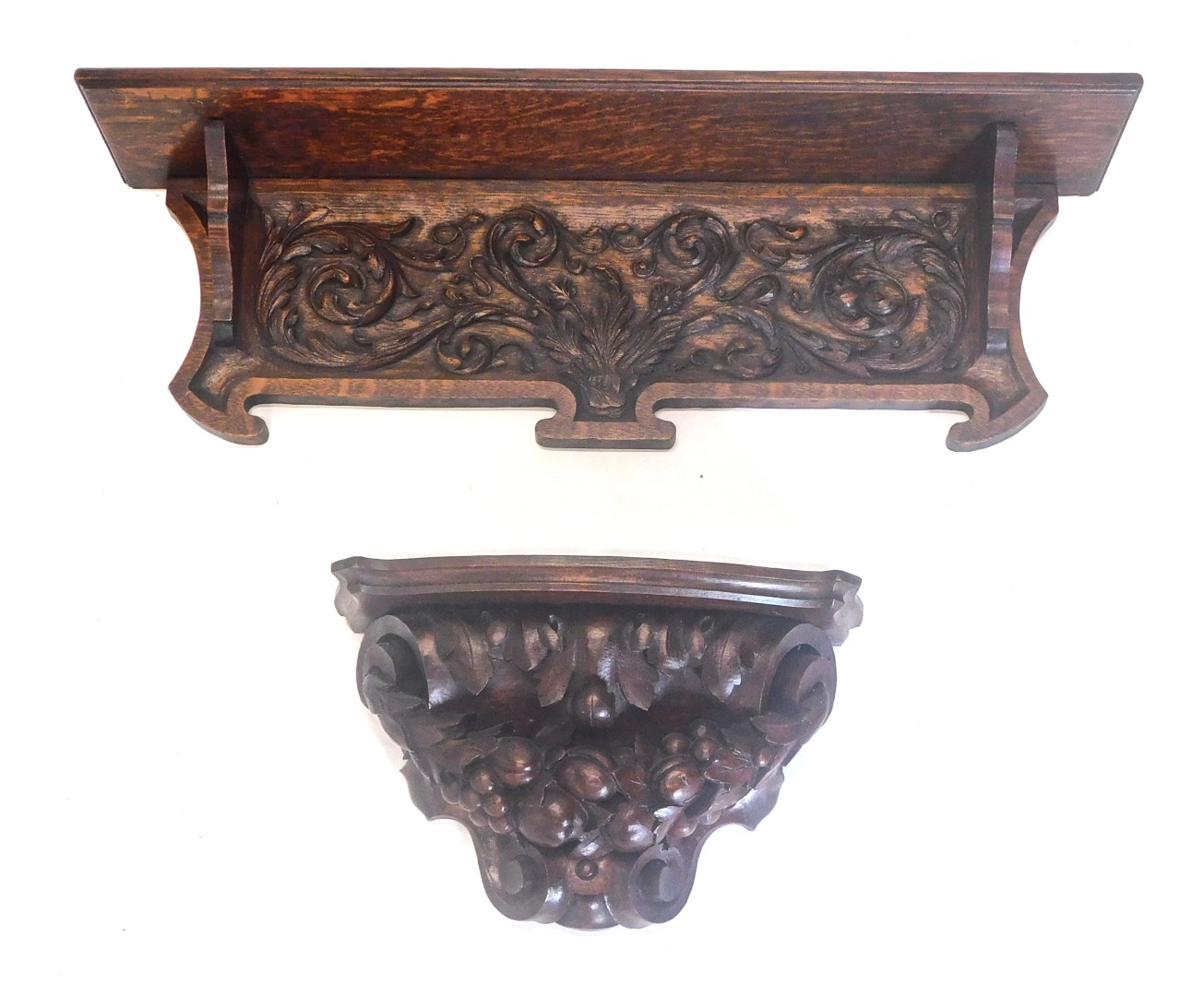 A late 19thC carved oak wall shelf, with shaped base, 74cm wide, and similar wall bracket or shelf,