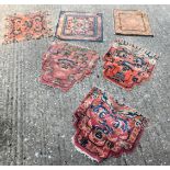 A collection of late 19th/early 20thC Chinese small rugs or mats, mainly cut from fragments, etc., v