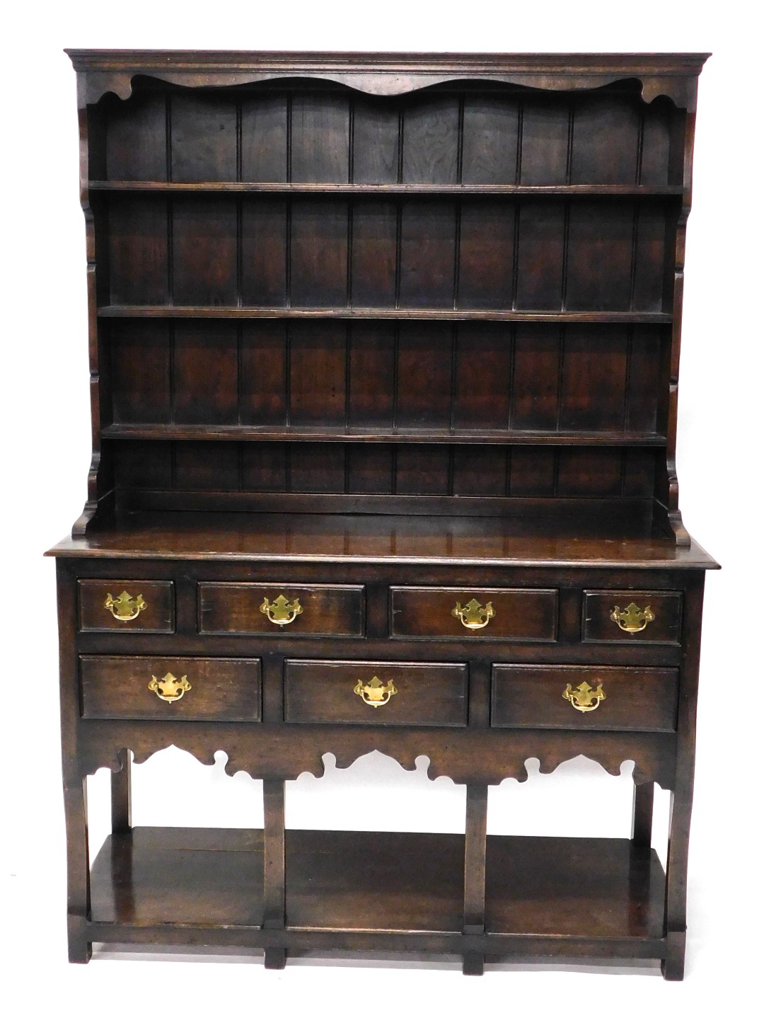 An oak dresser in 18thC style, the plate rack with three shelves on end supports, the base with a mo