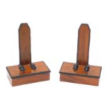 A late 19th/early 20thC figured mahogany and ebonised plate stands, after a design by Gillows, with