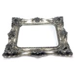 A large silvered rococo style wall mirror, rectangular bevelled plate, the frame decorated with scro