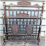 An unusual late 19thC mahogany and brass bed head and foot, with carved crests, cylindrical frame, e