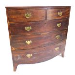 A George III mahogany bow front chest of two short and three long graduated drawers, with brass soli