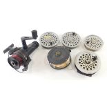 A Shakespeare 2755 graphite fishing reel, 9cm diameter, a fixed spoon reel, and four others. (6)