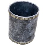 A black and gilt tooled leather cylindrical waste paper basket, 35cm high, 30cm diameter. This lot i