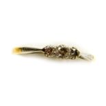 An 18ct gold, platinum and diamond three stone ring, claw set, approx 1/8th carat, size R, 1.9g.